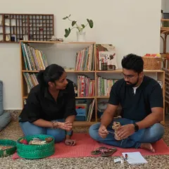 An AMI guide in conversation with a parent during a workshop. We are here to sit beside you, answer your questions, and share insights as you explore the Montessori method and your own parenting path.