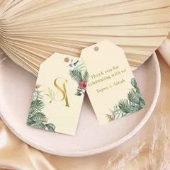 Small tags, big impressions. These custom gift tags feature a tropical leaf design and a gold foil monogram, perfect for adding a touch of magic to wedding favors and thank you gifts.