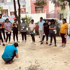 An instructor demonstrates the proper technique for Jal Neti to a group of students before they begin their own practice.
