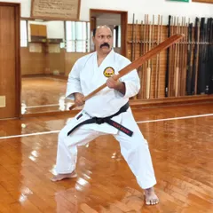 Kobudo, the art of Okinawan weapons, is an integral part of our curriculum. This is me demonstrating a stance with a traditional Eku (oar), a practice that develops strength, coordination, and a deeper understanding of martial principles beyond empty-hand techniques.