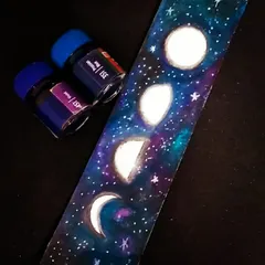 This bookmark captures the mesmerizing phases of the moon against a deep blue and purple galaxy. I painted this celestial design with watercolours, making it a wonderful gift for any book lover who enjoys stargazing.