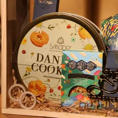 A close-up of the goodies inside one of my Diwali hampers, featuring Danish cookies, Indian sweets from Bombay Sweet Shop, and handcrafted accessories.