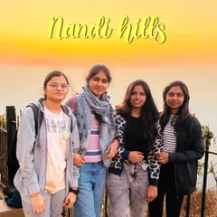 A group of friends posing against the beautiful golden sunrise at Nandi Hills. It's one of the most popular and accessible sunrise spots near Bangalore.