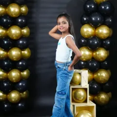 A stylish pose from a young girl during her studio birthday session, showing off her cool and confident personality.