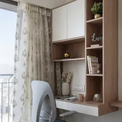 With the rise of remote work, a dedicated study table is essential. I integrated this compact workspace into the bedroom, providing storage for files and a niche to display cherished artifacts.