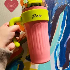 Our personalised insulated tumbler with a handle, shown here in a vibrant pink and neon yellow combination. The two way lid is leak proof and perfect for taking your beverage on the go.