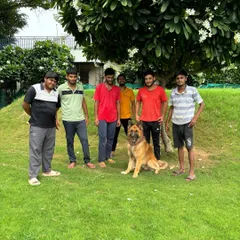 This is my dedicated team with Oscar, a German Shepherd, after a successful training session. We work together to provide consistent care and reinforcement for all the dogs staying with us.