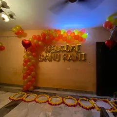 A full view of the welcome decoration I set up. It combines a modern balloon arch with a traditional flower pathway on the floor, creating a beautiful blend for the newlyweds' arrival.