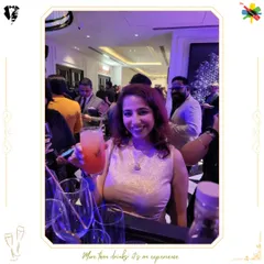 A smiling guest holds up her drink for a photo. Our goal is to create cocktails that are not only delicious but also picture-perfect.