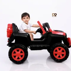 A toddler enjoys a ride in a toy jeep, looking ready for an adventure. These playful portraits are a great way to capture the energy and fun of the toddler years.