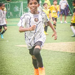 The determination on a player's face as he sprints during a game. We build champions through hustle and hard work.