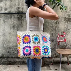 Here’s another look at our vibrant granny square tote bag. The combination of bright, multi-colored squares against a neutral base makes it a statement piece that’s still easy to style.