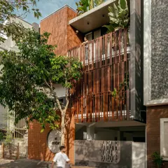 The 'Ittige' residence is designed to be a part of its streetscape, with a facade that interacts with the surrounding trees and allows for views from within.