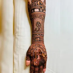 It was a pleasure creating this intricate bridal design for a client from abroad, incorporating traditional Indian wedding scenes, including a couple portrait and an elephant motif.