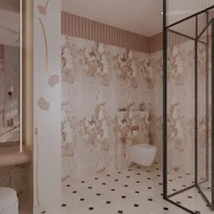 This view highlights the material palette of the bathroom, where pink-toned marble-effect stone meets fluted wall panels. A simple, wall-mounted toilet maintains the clean and uncluttered feel of the space.