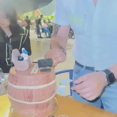 A customer enjoying the interactive feature of our working barrel cake. It's a 2kg chocolate truffle cake that's as fun as it is delicious.