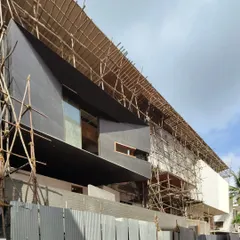 The 'House of Reddys,' a 30,000 sq ft mansion, during the construction phase. The image shows the complex scaffolding required for its ambitious, angular facade.