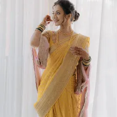 A full-length portrait of the bride in her beautiful yellow saree, looking ethereal and elegant.