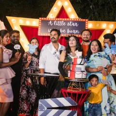 A moment of pure joy and celebration with family and friends. The themed backdrop and props bring everyone together for fun photos and lasting memories at this movie premiere baby shower.
