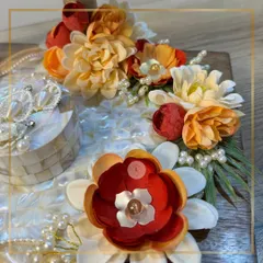 The texture and detail of our handcrafted flowers. We carefully select and arrange each bloom, like these burnt orange and red flowers, to create a rich and beautiful composition on the mother-of-pearl platter.