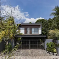 Exterior views of the Mango Tree Yard home, highlighting its contemporary form, clean lines, and the use of screens for privacy and ventilation.