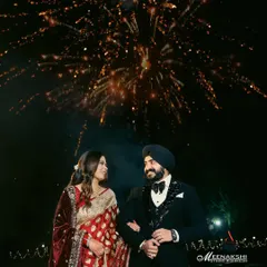 A magical reception night captured under a sky full of fireworks. I focus on framing these grand celebrations to feel both spectacular and deeply personal, highlighting the couple's joy amidst the sparkle.