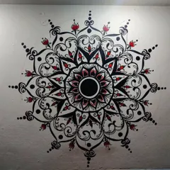 Adding pops of red to bring the mandala to life. This stage is where the personality of the piece really starts to shine through, highlighting specific elements within the complex geometric design.