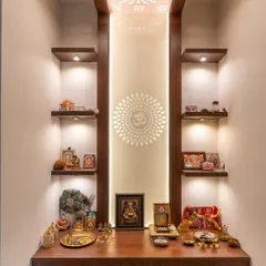 A serene and minimal puja unit with a backlit CNC-cut 'Om' symbol, sleek walnut shelves, and integrated downlights.