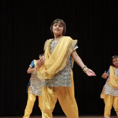 Our student striking a confident pose during her group performance. We create a supportive environment where every child feels like a star.