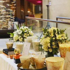 I also provide smaller floral bouquets for table settings. These arrangements feature white lilies and carnations in simple vases, perfect for adding elegance to any table.