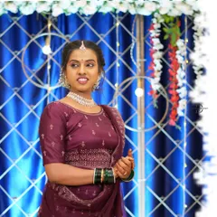 A candid shot showcasing the client's happiness and the decor details. The backdrop of blue drapes, lights, and floral arrangements adds to the celebratory feel of the event.