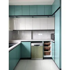 A modern kitchen is a blend of clean aesthetics and smart functionality. This bespoke kitchen in a vibrant teal features high-gloss cabinetry, integrated appliances, and ample counter space, designed for a seamless culinary experience in a contemporary Bengaluru home.