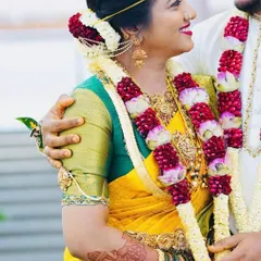 A heartwarming photo of the bride and groom. You can see a glimpse of her bridal mehendi on her arm as they share a happy moment together.