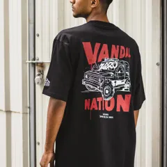 Another lifestyle shot of the 'Vandal Nation' T-shirt against an industrial background, highlighting its street-style aesthetic.