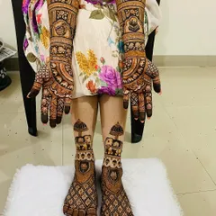 A complete bridal mehndi set for a truly royal look. This design covers both hands and feet with coordinated patterns, featuring traditional elephant motifs, intricate jaal work, and auspicious symbols for a cohesive and stunning bridal look.