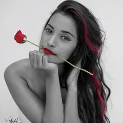 A close-up version of my selective color series. This black and white portrait with pops of red draws all the attention to the model's face, creating a striking and intimate artistic shot.
