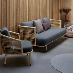 A different angle of our cane sofa set, highlighting the craftsmanship of the rounded armchair and the clean lines of the sofa. We can customize cushion fabric and dimensions to fit your specific interior design needs.