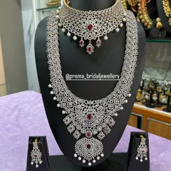 A glamorous American Diamond choker and long necklace set. This piece is perfect for receptions, with its brilliant sparkle and ruby-colored stones.