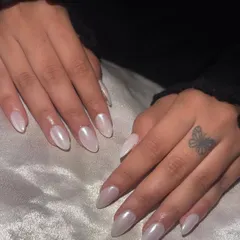 A simple, elegant, and incredibly popular choice: a full set of white chrome nails for a pearly, glazed finish.