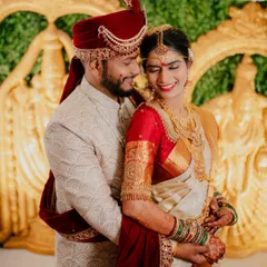 A classic and elegant portrait of the couple in their traditional wedding attire, sharing a happy and intimate moment.