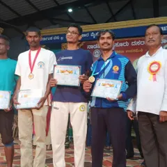On the podium after winning first prize at the Mysore Dasara Yogasana Competition in 2024. This is a prestigious state level event that attracts serious competitors.