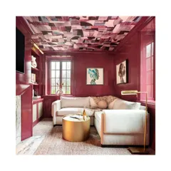 This living room demonstrates how wallpaper on the ceiling can elevate a space. The abstract, colourful pattern adds a surprising and artistic element, drawing the eye upward and making the room feel more dynamic.