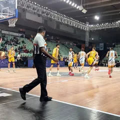 The court is where legends are made. A referee's view of an intense game in progress, with players moving quickly and strategically. Every possession counts in moments like these.