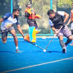 I am a coach who still loves to play the game. This action shot from a match shows me in the middle of the action. This experience helps me relate to my players and understand the game from their perspective.