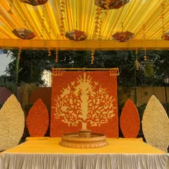 We created this beautiful 'Tree of Life' backdrop entirely from fresh marigold flowers. Paired with a traditional brass urli, this Haldi stage is a unique piece of floral art that celebrates our traditions.