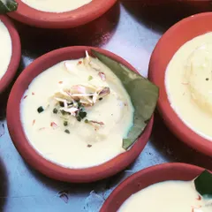 A close-up of my Kesar Rasmalai, soaking in fragrant, saffron-infused milk. I serve this classic Bengali sweet in traditional kulhads to maintain its authentic taste and texture.