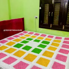 This bright and cheerful crochet bedsheet was made for a client's bedroom. The pattern uses solid granny squares for a modern, geometric look that is both warm and stylish.