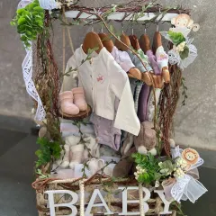 We redefine baby gifting with creative and enchanting concepts. This unique hamper, designed as a miniature wardrobe filled with adorable baby clothes and essentials, is a perfect example of how we turn a simple gift into a cherished and unforgettable keepsake.