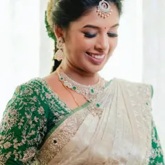 A close-up of Swathi's makeup, featuring a soft eye look and a bright smile.