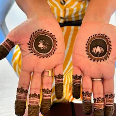 A minimal henna design for Karwachauth, featuring a lotus and a sieve motif inside small circles. This is a creative and modern way to incorporate traditional symbols into a simple design.